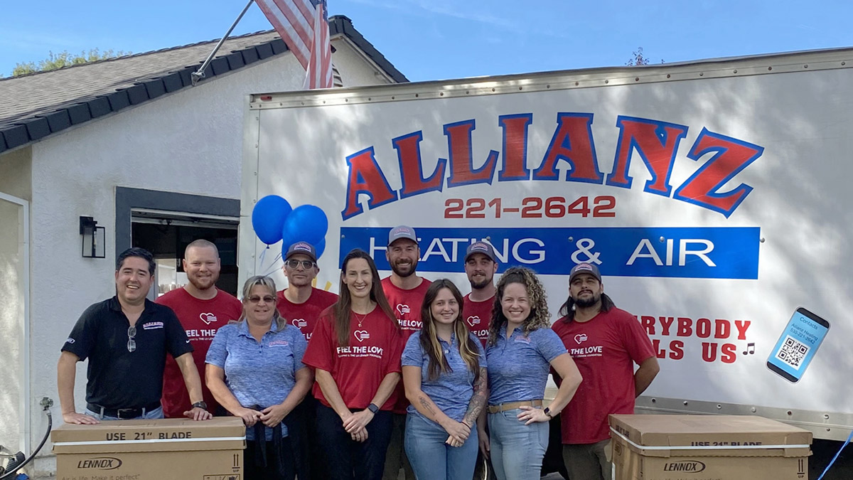 Allianz-Feel-the-Love-1200×675 Allianz Heating and Air team standing in front of sign